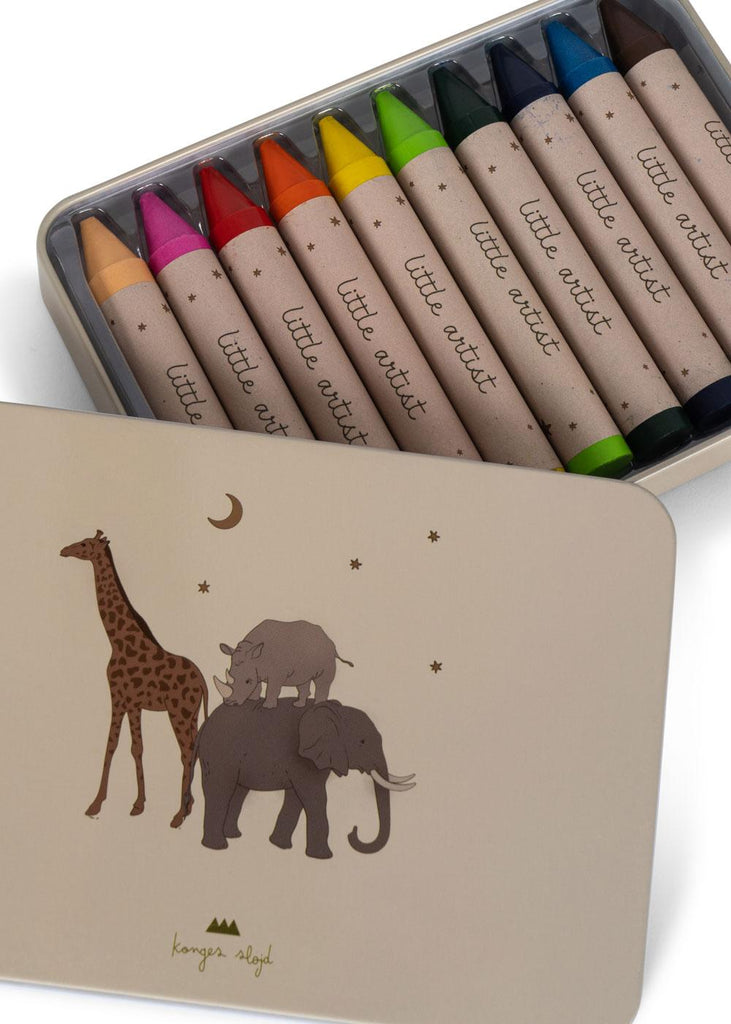 The Konges Sloejd Beeswax Crayons - Safari come in a tin box with a giraffe, two elephants, stars, and a moon on the lid, containing ten colorful crayons labeled "little artist.
