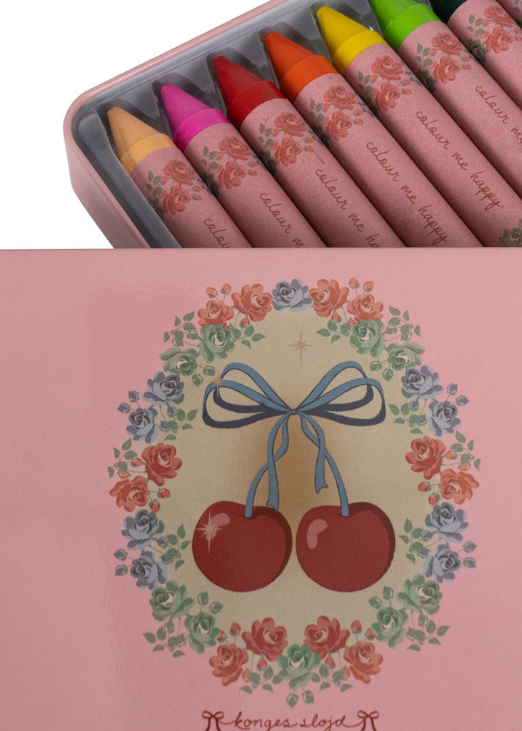 The Konges Sloejd Beeswax Crayons - Cherry Bow come in a pink tin box with a cherry and floral lid design, neatly filled with colorful, non-toxic crayons.