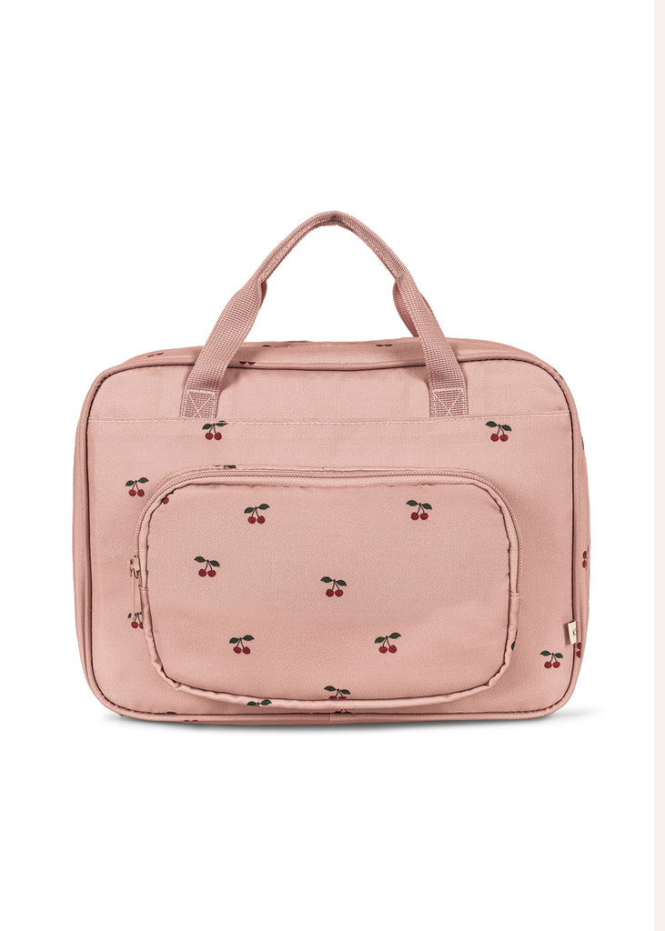 The Konges Sloejd Holiday Essentials Bag - Cherry is a light pink fabric bag with two handles, a cherry pattern, and a large front zippered pocket—ideal for holiday essentials or carrying kids’ stationery on the go.