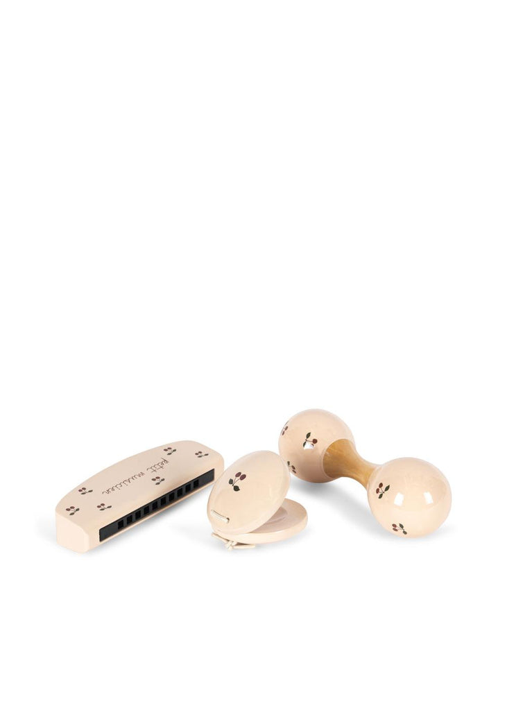 The Konges Sloejd Petit Music Set - Glossy Cherry features three cream-colored wooden instruments—a harmonica, castanets, and double-headed rattle—each adorned with black dot and line designs, displayed on a white background.