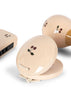 A close-up of three light wood instruments—a harmonica, castanets, and a maraca—each with a painted cherry design from the Konges Sloejd Petit Music Set - Glossy Cherry, perfect for kids’ musical play.
