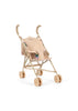 Konges Sloejd Tulle Doll Stroller - Rainbow Star features a beige design with curved handles, a gold-tone frame, and four sets of double wheels. The stroller has a textured seat adorned with embroidered floral patterns and is shown empty against a white background.