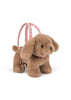 The Konges Sloejd Puppy Bag is a plush brown dog with floppy ears and a pink harness, worn as a backpack or used as an adorable kids handbag—perfect for little ones on the go.