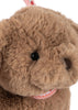 Close-up of the Konges Sloejd Puppy Bag shows its fluffy brown face, black plastic eyes, stitched brown nose, and soft fur. A pink and white ribbon completes this adorable kids handbag.