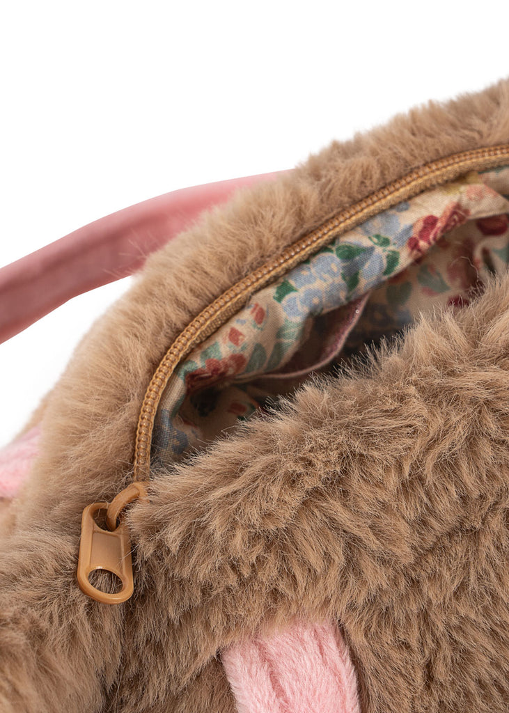Close-up of the Konges Sloejd Puppy Bag, a brown fluffy kids handbag with a tan zipper, pink detail, and floral fabric lining.