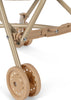 Close-up of the Konges Sloejd Doll Stroller - Colored Hearts lower frame, featuring double plastic wheels with flower cutouts and sturdy metal connectors.
