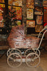 Konges Sloejd Mini Doll Pram - Sparkly Cherry Sequin featuring a vintage-style design with a sequined cherry pattern, set on a white frame with four wheels.