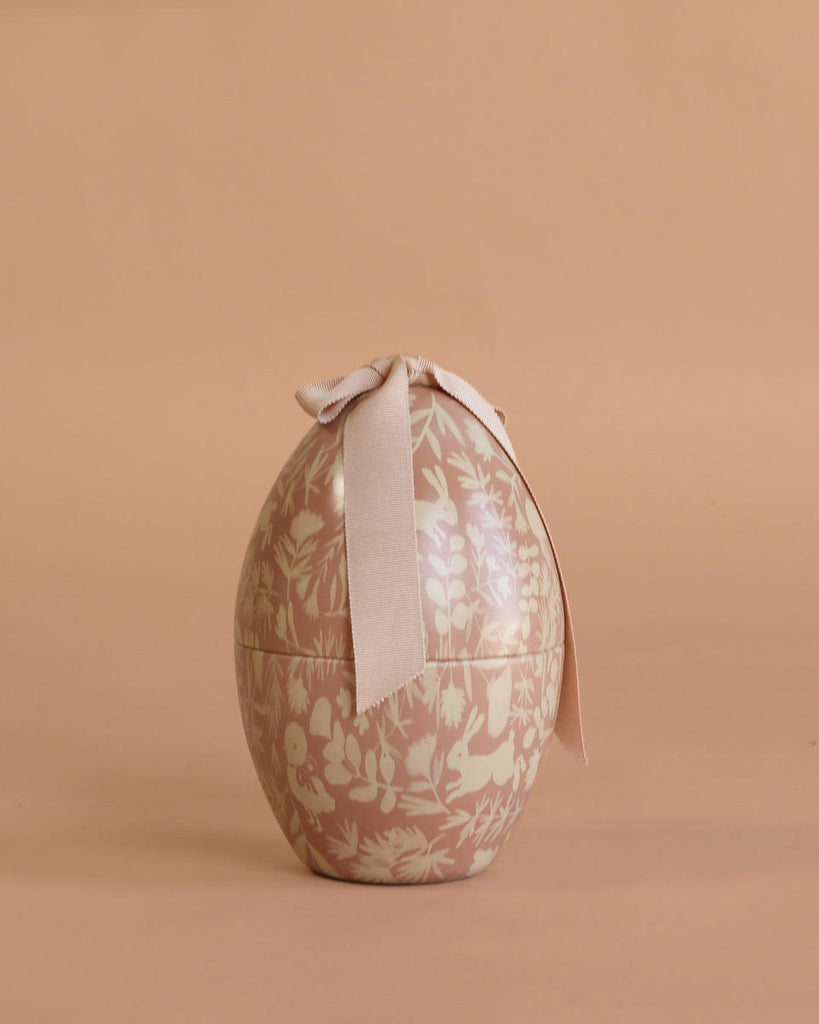 The Maileg Easter Egg with Bunny features a floral-patterned, egg-shaped box topped with a large cream ribbon—ideal for gifting this season and pairing beautifully with a plush bunny.