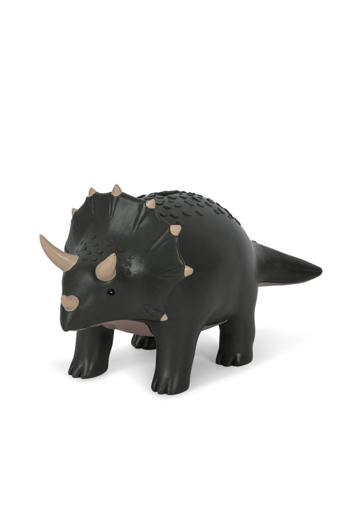 The Konges Sloejd Money Bank - Dino is a black and brown triceratops toy with three horns and textured details, perfect for encouraging savings, displayed on a white background.