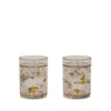 The Konges Sloejd Glitter Cups - Lemon (2 Pack) feature a subtle brown tint, yellow lemons, green leaves, and glittery dots—fun, stylish drinkware that brightens any table and is perfect for kids.