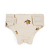 Konges Sloejd Doll Nursery Set - Lemon: Beige diaper cover with lemon print and velcro closure, made from organic cotton for dolls, shown flat on a white background.