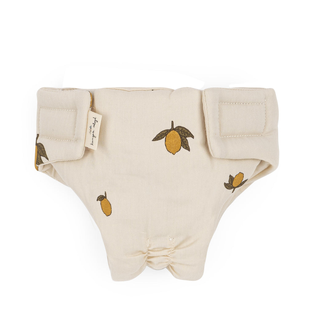 Konges Sloejd Doll Nursery Set - Lemon: Beige diaper cover with lemon print and velcro closure, made from organic cotton for dolls, shown flat on a white background.