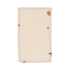The Konges Sloejd Doll Nursery Set - Lemon features a beige, rectangular organic cotton cloth with a subtle grid and small yellow lemon illustrations with green leaves in three corners, perfect as a doll accessory or bib. Laid flat on white background.