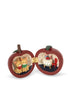 The Konges Sloejd Mini Surprise House - Cherry is an apple-shaped trinket box that opens to reveal a miniature world, with two kittens in one half and a tiny table and chair in the other.