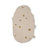 The Konges Sloejd Doll Sleeping Bag - Lemon features an oval shape, soft organic cotton fabric, and a beige cover adorned with small yellow lemons and green leaves, shown against a white background.