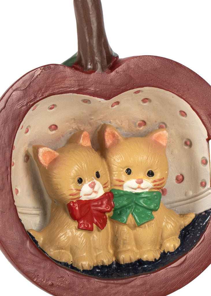 Two small orange kittens with red and green bows sit inside a Konges Sloejd Mini Surprise House - Cherry shaped like an apple.