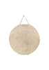 The Konges Sloejd Pop-Up Beach Tent UPF 50+ comes in a large, round bag with thin beige and white vertical stripes, two short beige handles, and a soft, slightly textured surface for easy portability.