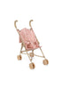 The Konges Sloejd Doll Stroller - Rosie Rose features curved handles, light brown wheels, and a pink seat with a red floral pattern, all shown against a white background.