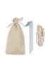 A striped beige drawstring bag, six metal tent stakes, and a coiled beige rope with a tensioner—accessories included with the Konges Sloejd Pop-Up Beach Tent UPF 50+—are displayed on a white background.