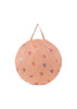 Round, peach-colored bag with handle, featuring colorful cherry motifs and tiny dots—ideal for carrying your Konges Sloejd Lace Pop-Up Beach Tent UPF 50+. Shown against a white background.
