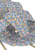 Close-up of the Konges Sloejd Doll Bouncer - Rose Flower, padded and covered with floral fabric in blue, pink, and green on a light background. A small white tag is visible on the bouncer for dolls.