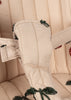 Close-up of a beige padded strap with quilted stitching and green bead embroidery, featured on the Konges Sloejd Tulle Doll Stroller - Cherry Sequin.