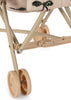 Close-up of the Konges Sloejd Tulle Doll Stroller - Cherry Sequin, showing four small plastic wheels, the metal frame, and fabric with a sequin butterfly design.