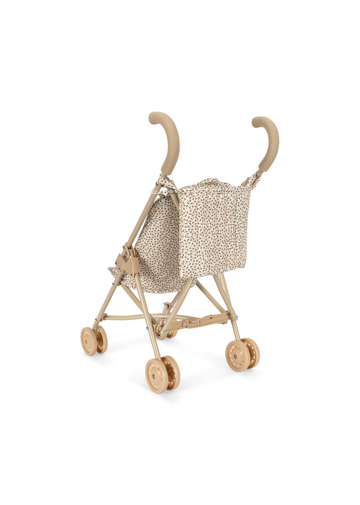 The Konges Sloejd Doll Stroller - Milk Tank is a beige stroller with curved handles and double wheels, featuring a fabric seat adorned with a tiny floral pattern.