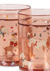 The Konges Sloejd Glitter Cup - Woof Letter Rose features a playful design with white dogs in red bows carrying envelopes, surrounded by colorful bones and hearts—a whimsical kids cup perfect for any occasion.