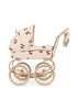 The Konges Sloejd Mini Tulle Doll Pram - Cherry Sequin features quilted beige fabric with a cherry print, light wooden wheels, a matching handle, and an attached bag—an elegant toy pram for kids to stroll their favorite dolls in style.