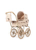 The Konges Sloejd Mini Tulle Doll Pram - Cherry Sequin features a quilted cream cover with cherry print, large spoked wheels, and a matching bag—ideal for kids who adore classic style.
