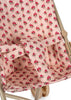 Close-up of the Konges Sloejd Doll Stroller - Rosie Rose, showing pink fabric with red rose and green stem pattern, beige frame, and visible safety straps.