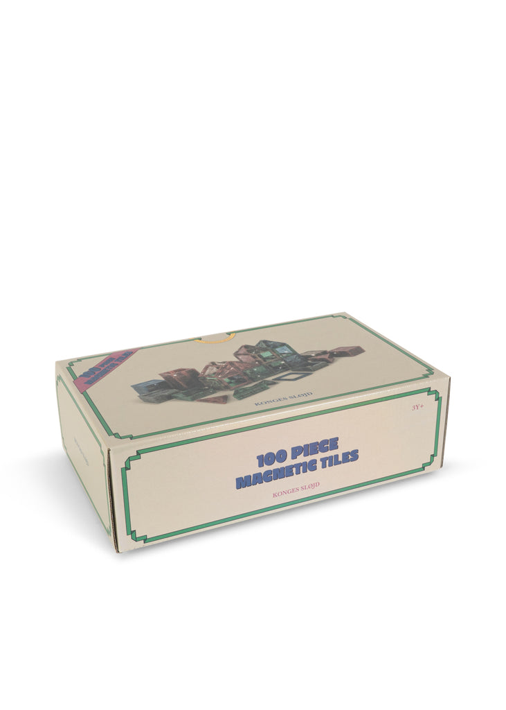 Box for a Konges Sloejd Piece By Piece Magentic Building Set featuring 100 magnetic tiles, illustrated with assembled structures and labeled “100 Piece Magnetic Tiles” and “3Y+.”