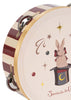 The Konges Sloejd Music Set - Circus includes a tambourine with a red and white striped edge, adorned with an illustration of a rabbit in a magician's hat surrounded by stars and decorative elements—a charming addition to any musical instrument collection.