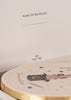 A close-up of a card with "Name of Musician" and a dotted line, shown above an illustrated round box adorned with a magic hat, wand, and stars from the Konges Sloejd Music Set - Circus—perfect for labeling your wooden instruments or adding to your music instrument collection.