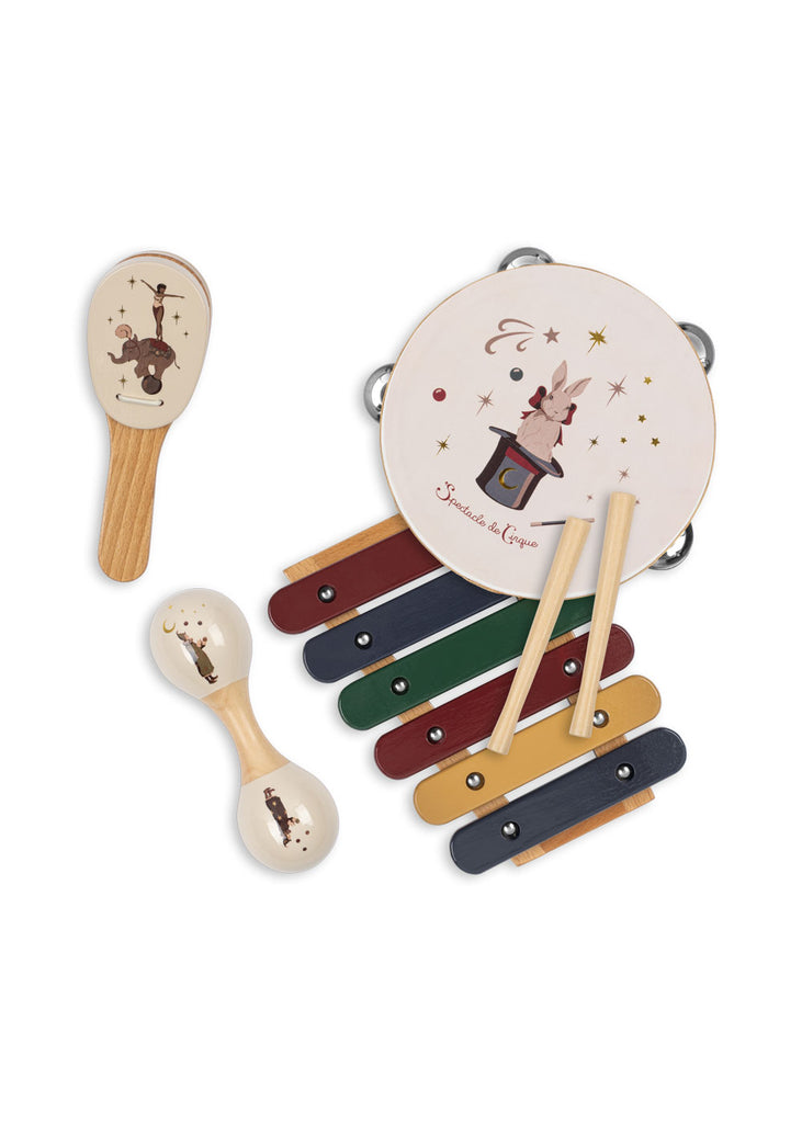 The Konges Sloejd Music Set - Circus features a tambourine, maraca, castanet, and xylophone with wooden sticks, each beautifully crafted from wood and adorned with playful circus-inspired animal illustrations on a white background. This enchanting set brings the joy of music to playtime, making every session feel like opening a magical suitcase of fun and creativity.