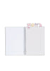 An open Konges Sloejd My Stationery Box - Unicorn A5 notebook with small, whimsical butterfly, star, and moon-shaped bookmarks extending from the top edge.
