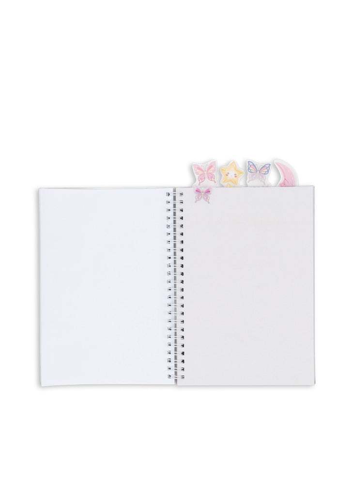 An open Konges Sloejd My Stationery Box - Unicorn A5 notebook with small, whimsical butterfly, star, and moon-shaped bookmarks extending from the top edge.