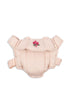The Konges Sloejd Doll Carrier - Cameo Rose is a pale pink cotton carrier with adjustable straps and a small embroidered flower on the front, shown on a white background.
