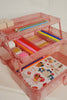 The Konges Sloejd Creative Art Caddy - Glitter Rose is a pink glittery organizer with three tiers, ideal for kids as an art kit or creative toolbox, and can neatly display pencils, pens, erasers, stickers, washi tapes, and colorful craft supplies.