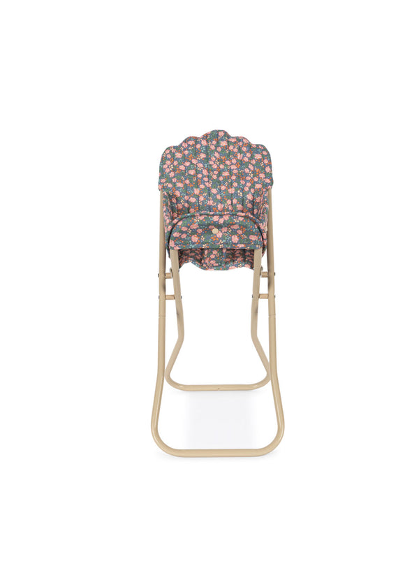 The Konges Sloejd High Chair - Kyoto is a foldable doll high chair with a beige metal frame and a padded, detachable seat cover in a pink, green, and white floral pattern. Photographed from the front against a white background.