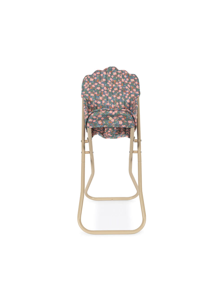 The Konges Sloejd High Chair - Kyoto is a foldable doll high chair with a beige metal frame and a padded, detachable seat cover in a pink, green, and white floral pattern. Photographed from the front against a white background.