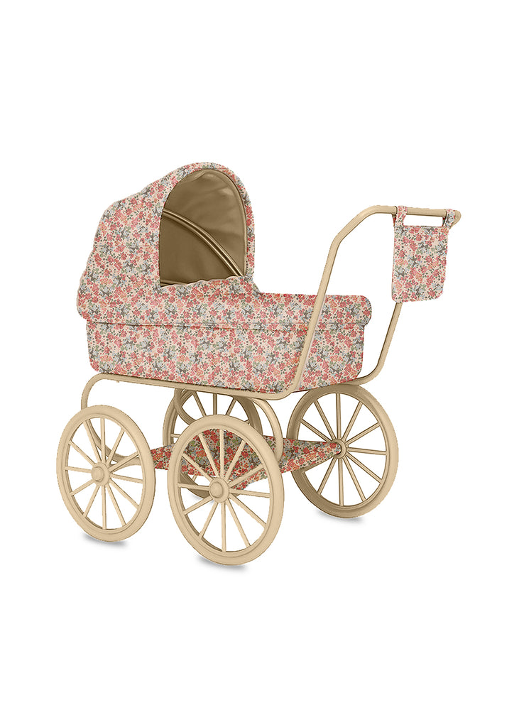 The Konges Sloejd Mini Doll Pram - Vienna features a vintage design with large spoked wheels, a floral-patterned canopy, body, and matching bag in soft pink and green tones, plus a charming light beige stroller frame.