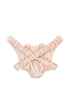 A light pink ruffled baby romper with crisscross straps and elastic leg openings is laid flat beside the Konges Sloejd Doll Carrier - Cameo Rose, creating a sweet matching set for playful moments.