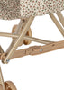 Close-up of the Konges Sloejd Doll Stroller - Milk Tank, featuring a beige frame with floral fabric, double wheels, support bars, and a locking mechanism.