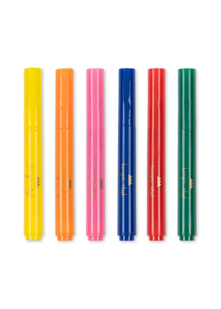 The Konges Sloejd Creative Art Caddy in Glitter Rose is the perfect addition to any kids' art supplies collection or creative toolbox, featuring six vibrant markers—yellow, orange, pink, blue, red, and green—arranged vertically against a crisp white background.