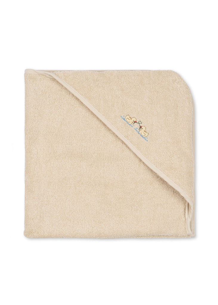A Konges Sloejd Organic Cotton Baby Towel, beige in color, is laid flat on a white background. The soft baby towel features a hood with a small embroidered design of two yellow ducks.