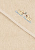Konges Sloejd Organic Cotton Baby Towel in beige, featuring an embroidered design of two yellow ducks facing each other and holding a green stem with red flowers, displayed on a textured surface with a diagonal seam.