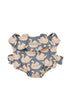 Konges Sloejd Doll Carrier - Swan in a blue-grey quilted fabric patterned with pink swans.