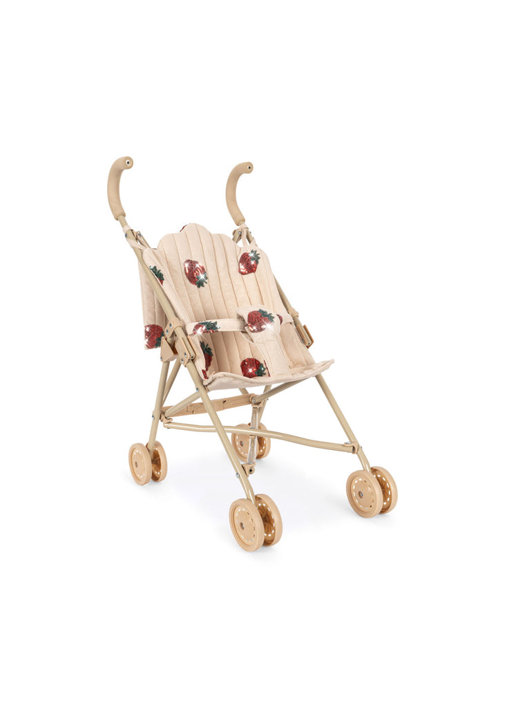 The Konges Sloejd Doll Stroller - Strawberry is a beige stroller with double wheels, curved handles, and a fabric seat featuring a red strawberry pattern.